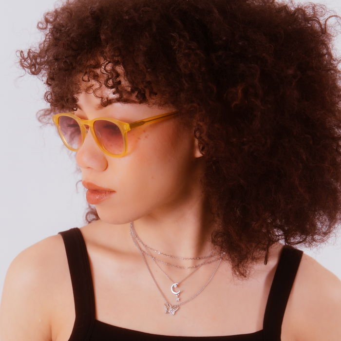 Photo of model with Model 138 vintage rose sunglasses on and a white background